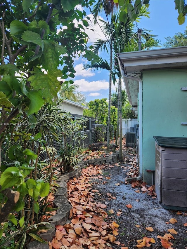 view of patio with central air condition unit and fence