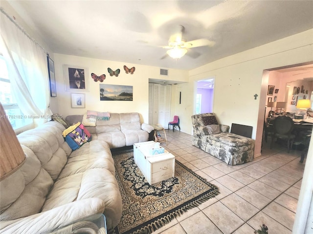 tiled living area with visible vents and ceiling fan