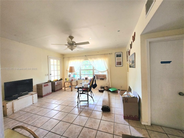 living area with visible vents, light tile patterned floors, and ceiling fan