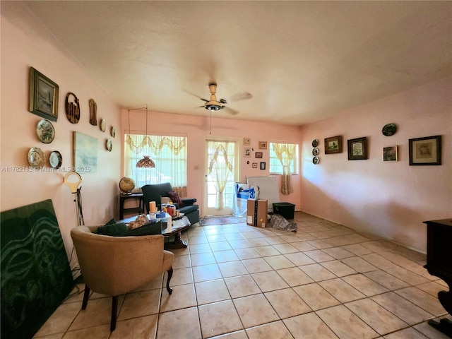 sitting room featuring light tile patterned floors and a ceiling fan