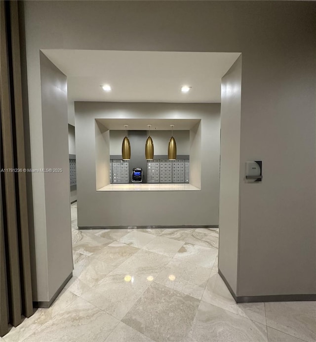 hallway with marble finish floor, baseboards, and recessed lighting