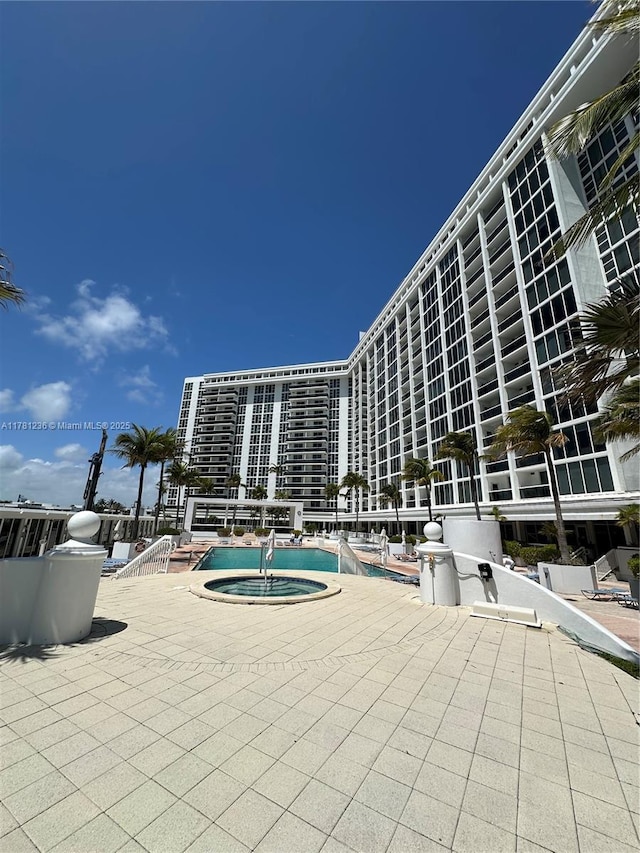 view of pool featuring a patio area and a community hot tub