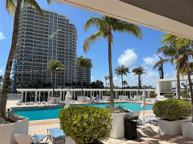 community pool featuring a patio and fence