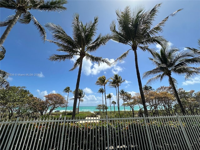 exterior space with a water view and fence