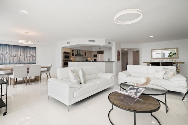 living area with light tile patterned floors, recessed lighting, and visible vents
