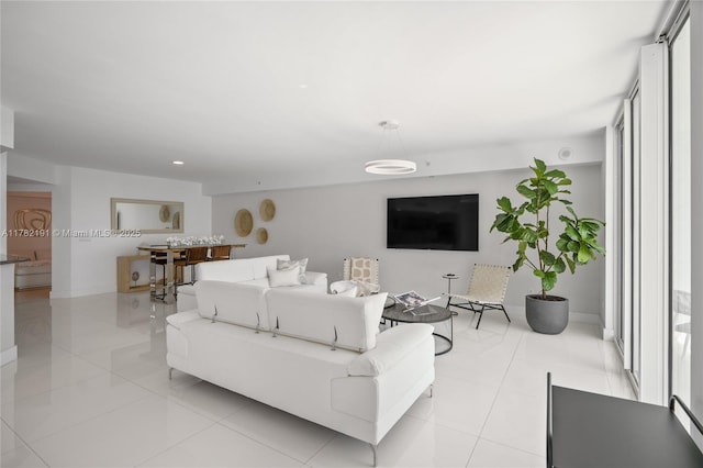 living room featuring recessed lighting, baseboards, and light tile patterned floors