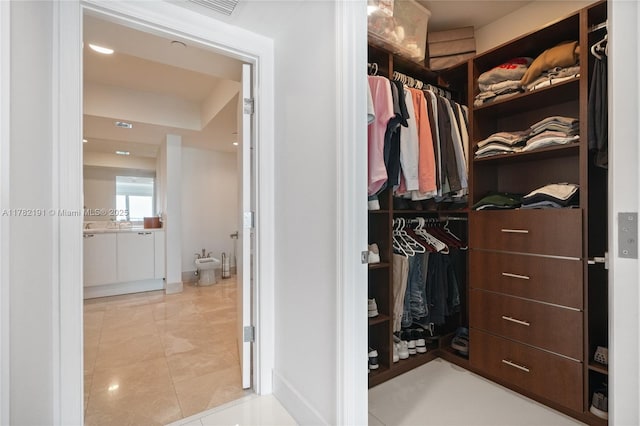 spacious closet featuring tile patterned floors and visible vents