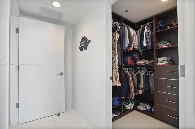 walk in closet featuring visible vents and tile patterned floors