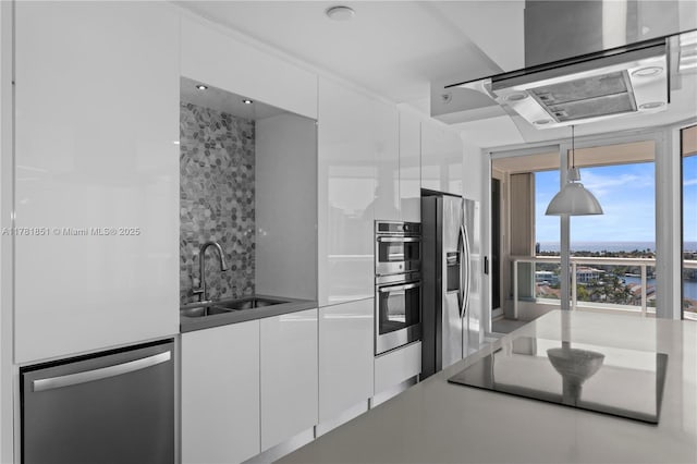 21055 Yacht Club Dr Unit 1409, Aventura, FL 33180 - kitchen with a sink, hanging light fixtures, modern cabinets, white cabinets, and appliances with stainless steel finishes