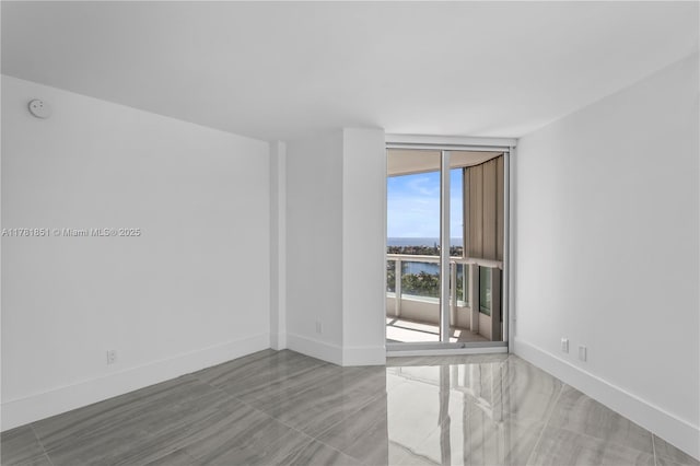 21055 Yacht Club Dr Unit 1409, Aventura, FL 33180 - unfurnished room featuring baseboards, floor to ceiling windows, and a water view