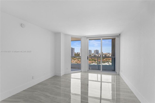 21055 Yacht Club Dr Unit 1409, Aventura, FL 33180 - spare room with a view of city, light tile patterned flooring, and baseboards