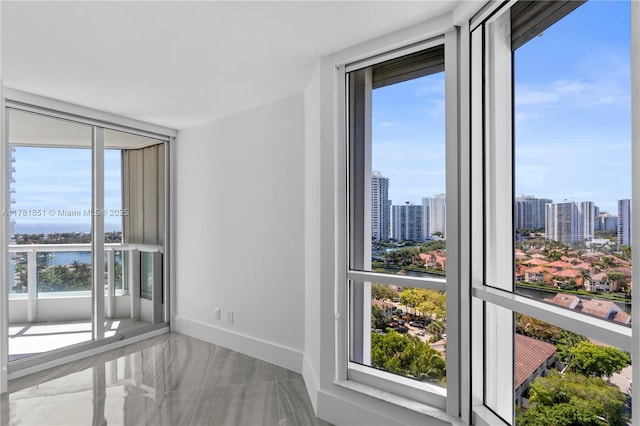 21055 Yacht Club Dr Unit 1409, Aventura, FL 33180 - unfurnished room featuring a wall of windows, baseboards, a view of city, and a healthy amount of sunlight