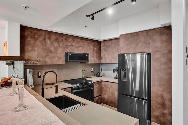 1755 E Hallandale Beach Blvd Unit 1608E, Hallandale Beach, FL 33009 - kitchen featuring stainless steel fridge, range with electric cooktop, a sink, light countertops, and backsplash