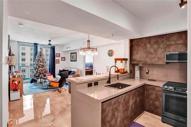 1755 E Hallandale Beach Blvd Unit 1608E, Hallandale Beach, FL 33009 - kitchen with stainless steel appliances, a sink, a peninsula, open floor plan, and light countertops