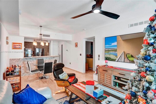 1755 E Hallandale Beach Blvd Unit 1608E, Hallandale Beach, FL 33009 - living area featuring a ceiling fan, a chandelier, and baseboards