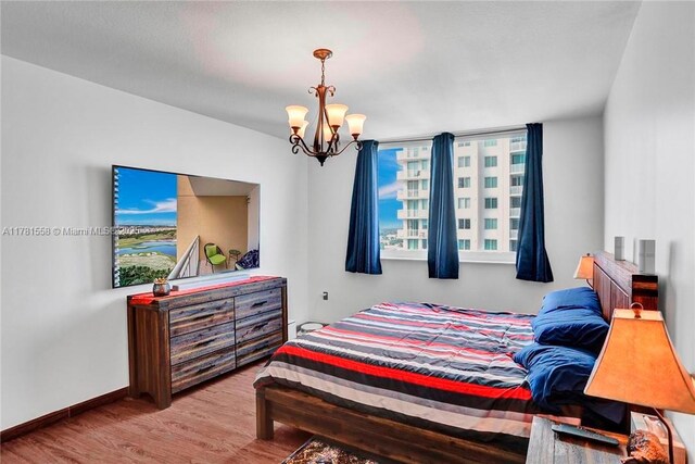 1755 E Hallandale Beach Blvd Unit 1608E, Hallandale Beach, FL 33009 - bedroom featuring a chandelier, wood finished floors, baseboards, and multiple windows