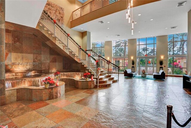 1755 E Hallandale Beach Blvd Unit 1608E, Hallandale Beach, FL 33009 - lobby featuring a towering ceiling, recessed lighting, stairs, and floor to ceiling windows