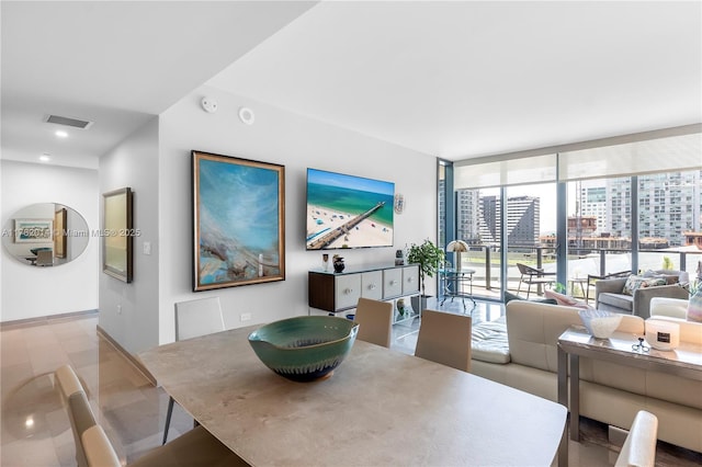 68 SE 6th St Unit 810, Miami, FL 33131 - dining area featuring floor to ceiling windows and baseboards