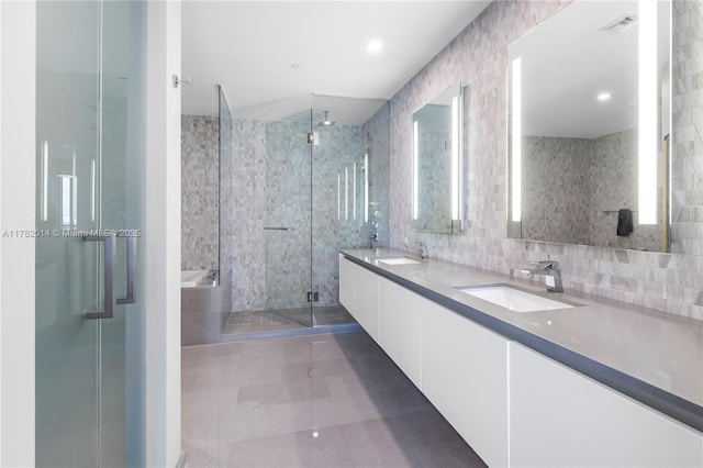 68 SE 6th St Unit 810, Miami, FL 33131 - full bathroom featuring a stall shower, double vanity, a garden tub, and decorative backsplash