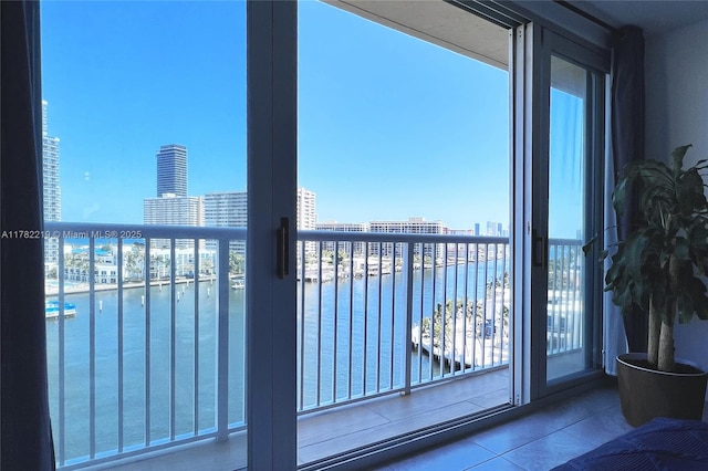 balcony featuring a water view and a city view