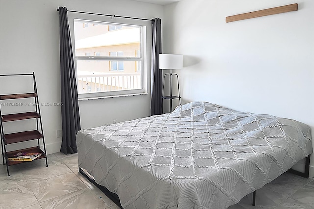 bedroom featuring marble finish floor
