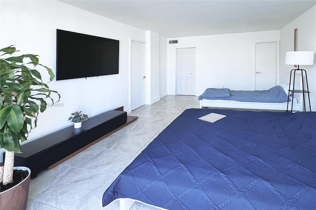 bedroom with marble finish floor and visible vents