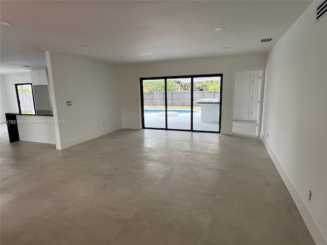 unfurnished room with baseboards, visible vents, and recessed lighting