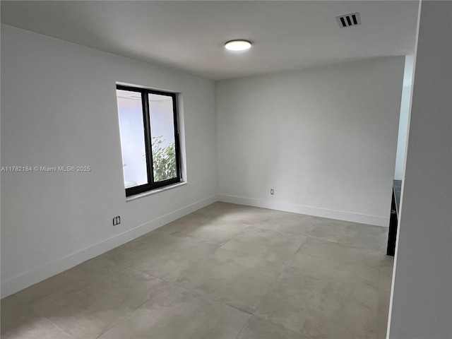 spare room featuring visible vents and baseboards