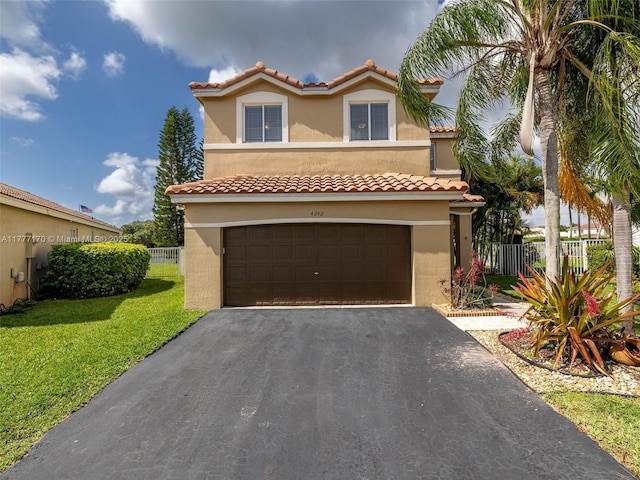mediterranean / spanish house featuring aphalt driveway, stucco siding, fence, and an attached garage