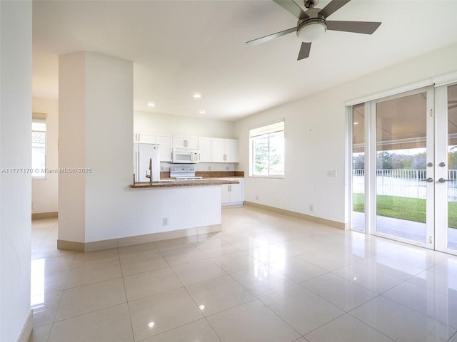 unfurnished living room with light tile patterned floors, baseboards, a ceiling fan, recessed lighting, and french doors