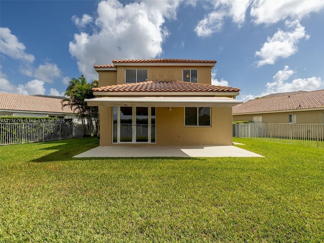 back of house featuring a patio, stucco siding, a fenced backyard, a yard, and a tiled roof