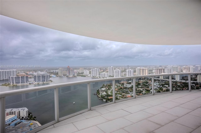 balcony featuring a city view and a water view