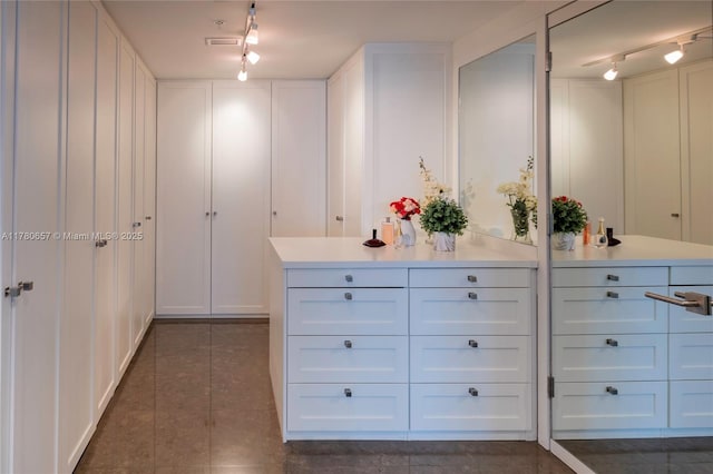 walk in closet with dark tile patterned floors