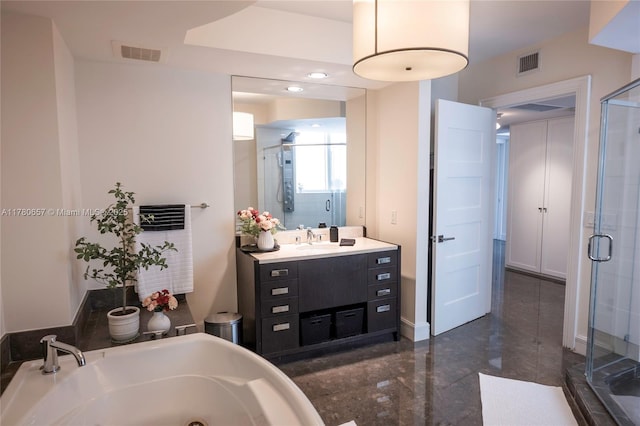 bathroom with a jetted tub, vanity, a stall shower, and visible vents