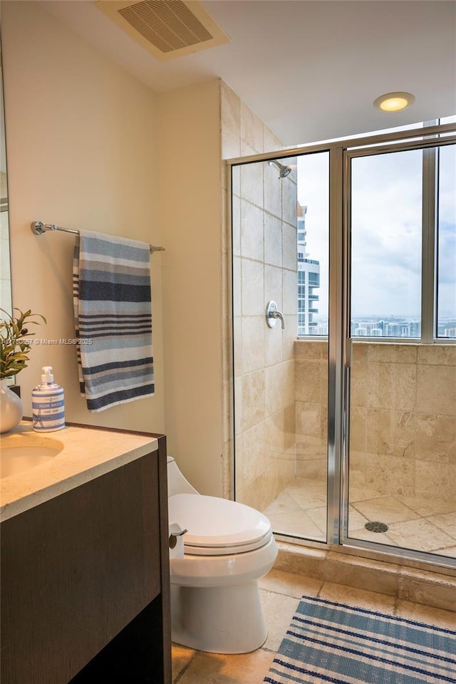 full bathroom with vanity, a stall shower, toilet, and visible vents
