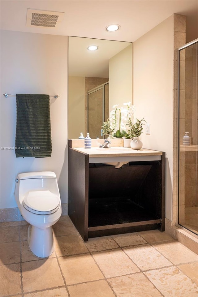 bathroom with vanity, toilet, recessed lighting, visible vents, and a stall shower