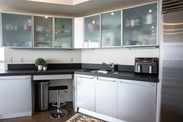 bar with a sink and stainless steel built in refrigerator