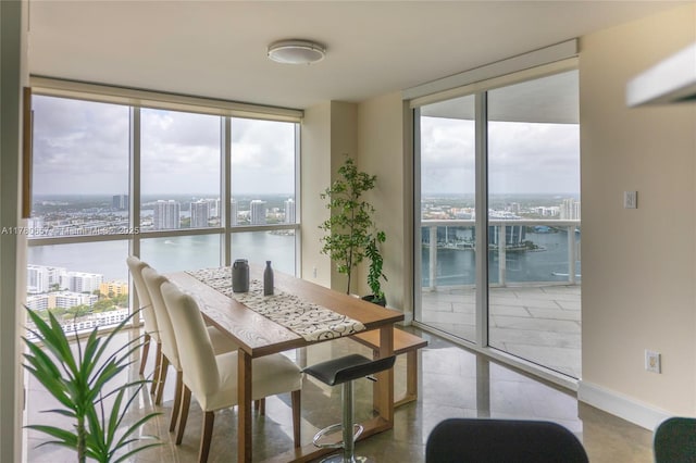 dining room featuring a view of city, floor to ceiling windows, and a wealth of natural light