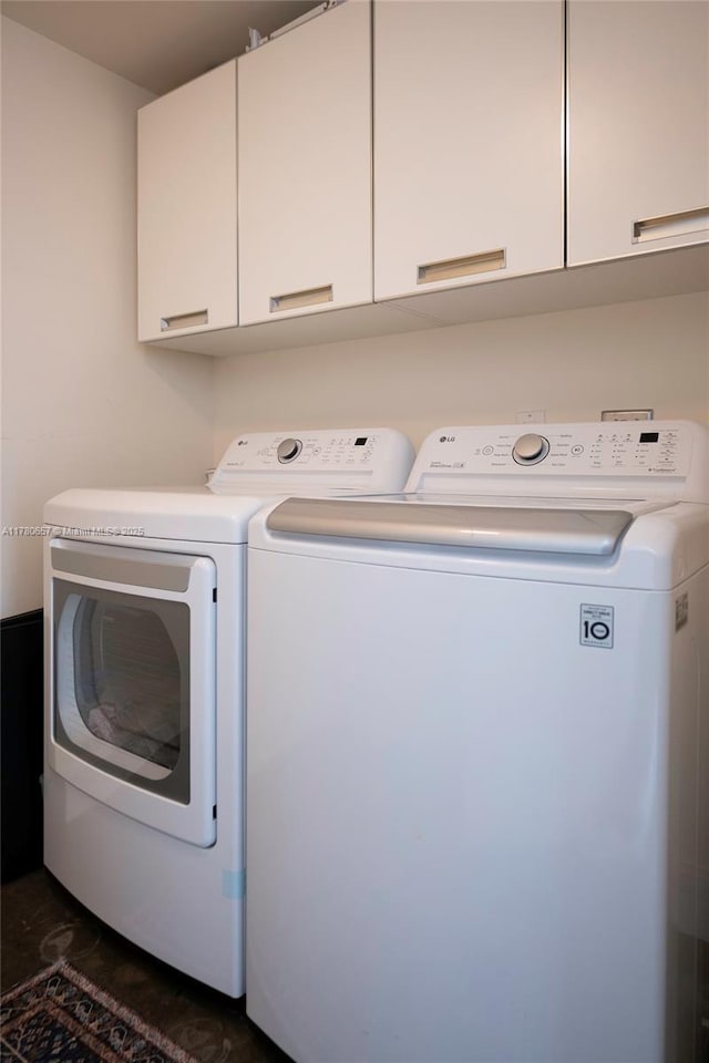 laundry room with cabinet space and washing machine and dryer