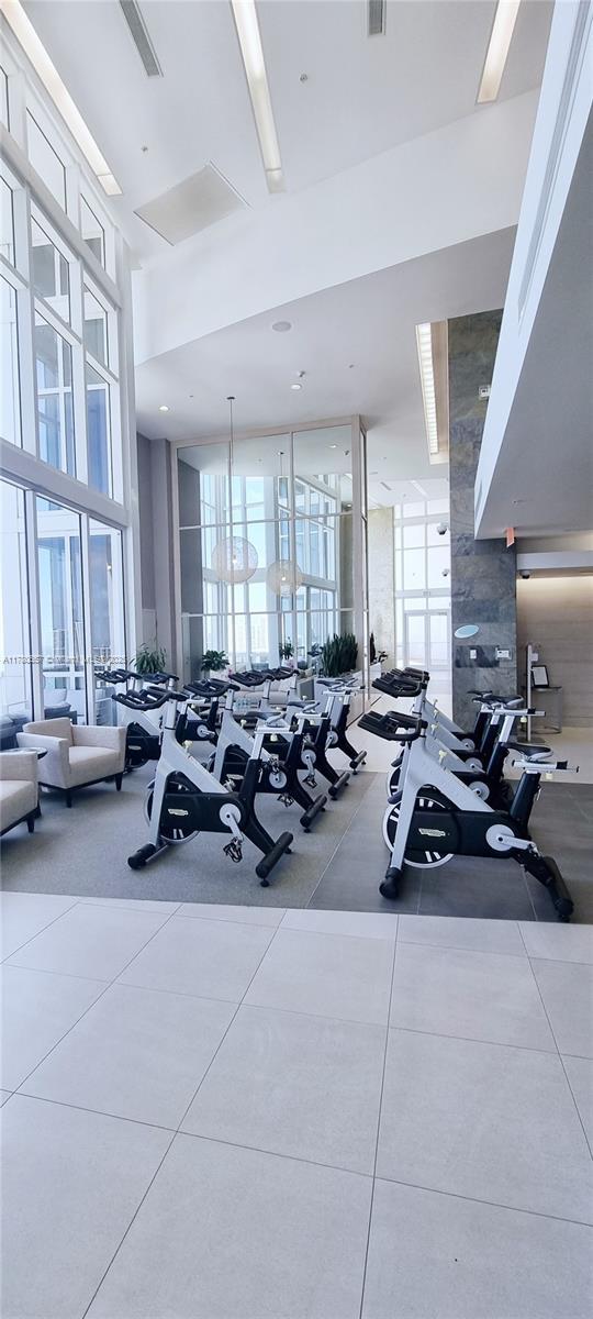 exercise room with a high ceiling