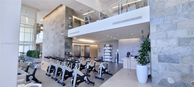 gym featuring visible vents and a towering ceiling
