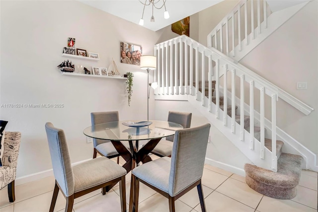 tiled dining room with stairway and baseboards