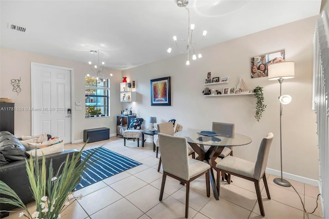 dining space with a chandelier, light tile patterned floors, baseboards, and visible vents
