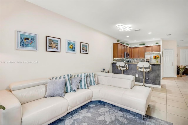 living room featuring light tile patterned floors, visible vents, and recessed lighting