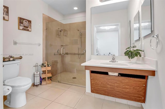 bathroom featuring toilet, vanity, a shower stall, and tile patterned flooring