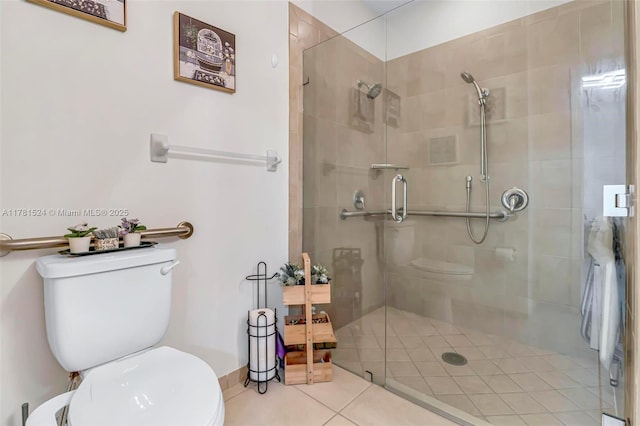full bath with a shower stall, tile patterned flooring, and toilet