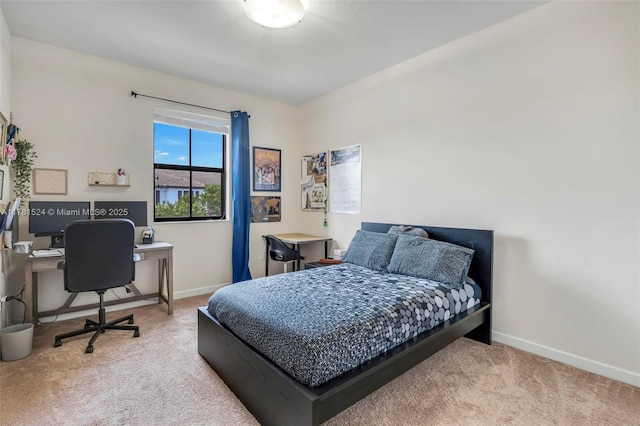 carpeted bedroom with baseboards