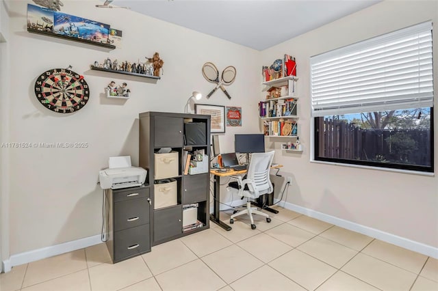 home office featuring light tile patterned floors and baseboards