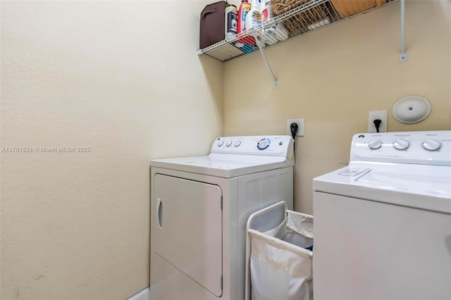 laundry area featuring washer and clothes dryer and laundry area