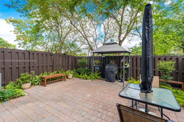 view of patio with a fenced backyard, a gazebo, and area for grilling